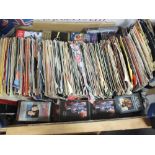A TRAY OF 7" SINGLES AND CASSETTE TAPES