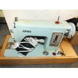 A CASED VINTAGE JONES ELECTRIC SEWING MACHINE