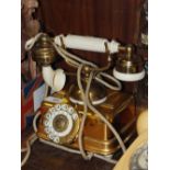 A VINTAGE BRASS TELEPHONE ON STAND