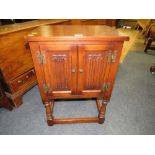 AN 'OLD CHARM' TWO DRAWER LINENFOLD CUPBOARD H-71 W-50 CM