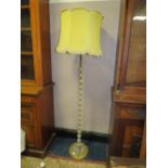 A VINTAGE GLASS AND BRASS EFFECT STANDARD LAMP