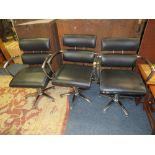 THREE BLACK & CHROME SWIVEL ARMCHAIRS