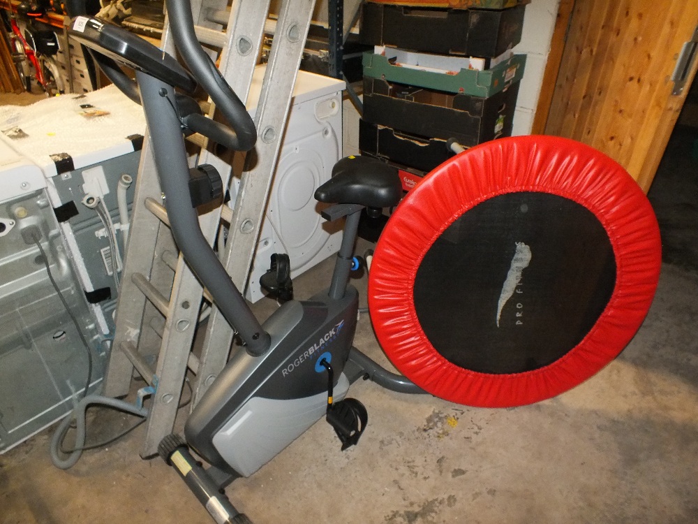 A ROGER BLACK FITNESS EXERCISE BIKE TOGETHER WITH AN EXERCISE TRAMPOLINE