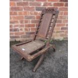 AN UNUSUAL CARVED EASTERN FOLDING CHAIR WITH ELEPHANT DETAIL