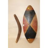 A LARGE ABORIGINAL CARVED PAINTED WOODEN SHIELD AND A BOOMERANG