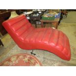 A MODERN RED SHAPED CHAISE S/D AND MARKED - IN NEED OF A CLEAN