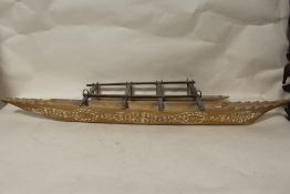 A LARGE POLYNESIAN SAMOAN(?) CARVED MODEL OUT RIGGER CANOE