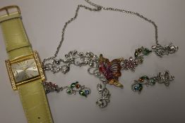 A JOAN RIVERS WRIST WATCH TOGETHER WITH A BUTTERFLY NECKLACE AND SIMILAR EARRINGS