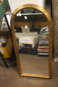 A MODERN GILT FRAMED ARCHED WALL MIRROR 41 CM X 89 CM