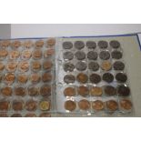 A BLUE ALBUM OF COINS CONTAINING A QUANTITY OF 1967 HALF PENNY AND ONE PENNY COINS AND A SELECTION