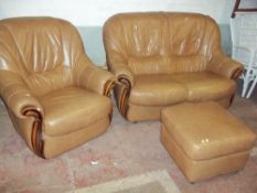 A THREE PIECE LEATHER ITALIAN STYLE SUITE COMPRISING A TWO SEATER SOFA, CHAIR AND STOOL