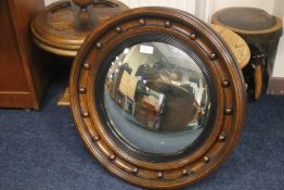 A WOODEN FRAMED CIRCULAR MIRROR