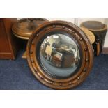 A WOODEN FRAMED CIRCULAR MIRROR