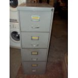 A VINTAGE FOUR DRAWER FILING CABINET WITH KEY
