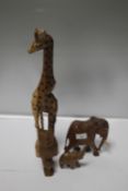 A COLLECTION OF CARVED AFRICAN ANIMALS TO INCLUDE A GIRAFFE, ELEPHANT AND AN OWL