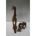 A COLLECTION OF CARVED AFRICAN ANIMALS TO INCLUDE A GIRAFFE, ELEPHANT AND AN OWL