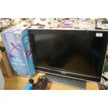 A 26" SONY BRAVIA FLATSCREEN TV AND A MAGNIFYING TABLE LIGHT