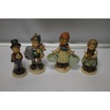 A COLLECTION OF FOUR GOEBEL FIGURES, THE BOY IN BROWN HAS TWO CHIPS, VARIOUS CRAZING TO ALL, ALL