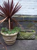 A RECONSTITUTED STONE PLANTER TROUGH AND A LARGE PLANTER