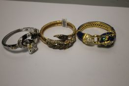 THREE BANGLES, ONE IN THE FORM OF A DRAGON, A SNAKE AND ANOTHER (3)