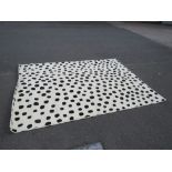 A LARGE MODERN SPOTTED RUG 228 X 200 CM