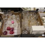 TWO TRAYS OF ASSORTED GLASSWARE TO INCLUDE A LARGE CUT GLASS VASE, CUT GLASS DRINKING VASES, BOXED