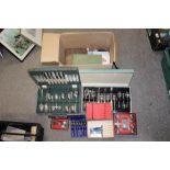 A BOX OF CUTLERY SETS AND PLACE MATS ETC.