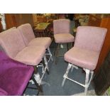 A SET OF FOUR MODERN SWIVEL UPHOLSTERED STOOLS