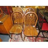 A SET OF FOUR WHEELBACK DINING CHAIRS