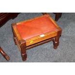 AN OAK LEATHER TOPPED FOOTSTOOL