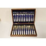 A MAHOGANY CASED CANTEEN OF SILVER PLATED MOTHER OF PEARL HANDLED CUTLERY