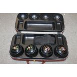 A CASED SET OF FOUR PREMIER LAWN BOWLS