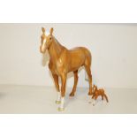 A LARGE BESWICK PALOMINO RACEHORSE TOGETHER WITH A PALOMINO FOAL - BOTH WITH CHIPS TO EARS