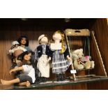 A COLLECTION OF PORCELAIN DOLLS TOGETHER WITH A TEDDY BEAR ON A SWING