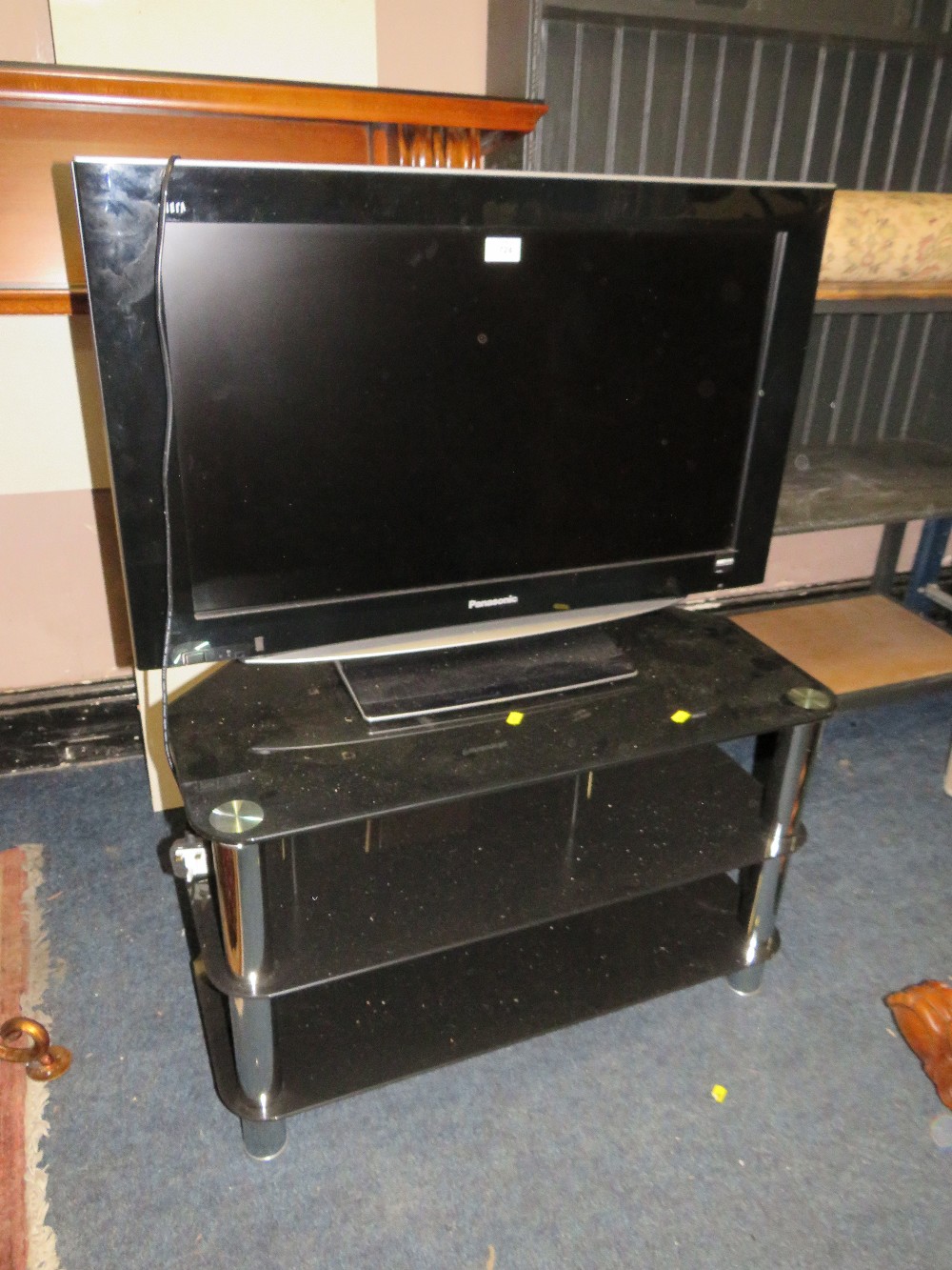 A PANASONIC FLATSCREEN 31" TV AND STAND - HOUSE CLEARANCE