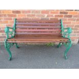 A CAST METAL WOODEN SLAT BENCH WITH LION DETAIL