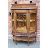 AN EDWARDIAN MAHOGANY INLAID AND PAINTED BOW FRONTED DISPLAY CABINET, the single glazed door