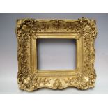 A LATE 18TH / EARLY 19TH CENTURY DECORATIVE GOLD SWEPT FRAME, width of frame 10 cm, frame rebate