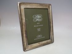 A LARGE HALLMARKED SILVER EASEL BACKED PICTURE FRAME, with hammered effect to border, overall H 26