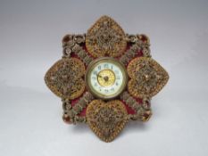AN ORNATE 19TH CENTURY DRESSING TABLE CLOCK, the shaped frame with pierced plated embellishment,