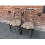 A PAIR OF VICTORIAN EBONISED BERGERE CHAIRS, with inlaid mother of pearl decoration