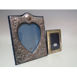 A LONDON HALLMARKED SILVER EASEL BACKED PICTURE FRAME, with embossed floral decoration and heart