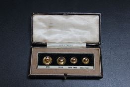 A CASED SET OF 9 CARAT GOLD BUTTONS, approx combined weight 3g, W 10 cm