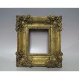 A 19TH CENTURY GOLD SWEPT MINIATURE PORTRAIT FRAME, frame W 6 cm, rebate 14 x 12 cm