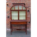 AN EDWARDIAN MAHOGANY INLAID DISPLAY CABINET OF UNUSUAL FORM, the upper section with two large