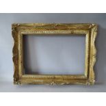 A 19TH CENTURY CARVED WOODEN SWEPT FRAME WITH GILT WASHES, frame W 7.5 cm, rebate 29 x 43 cm