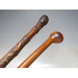 A VINTAGE HARDWOOD SPIRAL TWIST TAPERING WALKING CANE, L 82 cm, together with a vintage Oriental