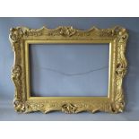 A 19TH CENTURY WOODEN GOLD SWEPT FRAME, with integral slip, frame W 8 cm, rebate 35.5 x 52.5 cm