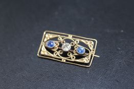 A DIAMOND AND SAPPHIRE BROOCH, set in unmarked yellow metal wirework brooch, approx weight 4.5g, W