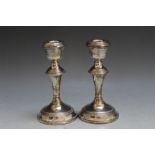 A PAIR OF HALLMARKED SILVER CANDLESTICKS - BIRMINGHAM 1969, having filled bases, H 14 cm